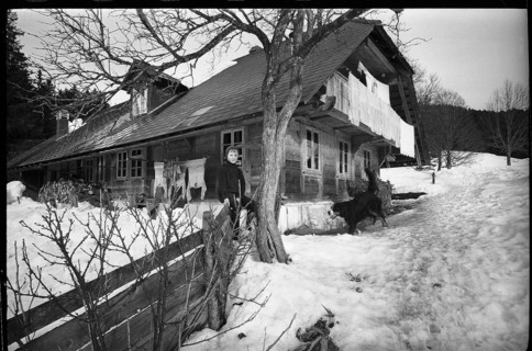 Boy in front of a farm house in the Emmental, 1970.