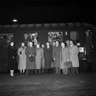 Group of workers travelling to the USA to share ideas and experiences posing for the photographer;