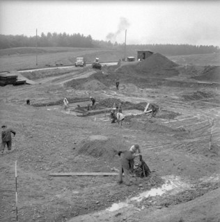 Workers preparing the ground for a drilling derrick; 1958.