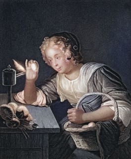 The egg test. a child curiously examines a chicken egg lit by a candle in a dark room. after a
