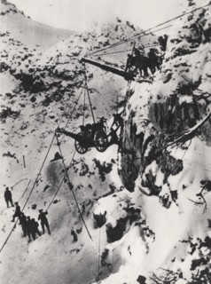 Carrying a cannon to a summit.