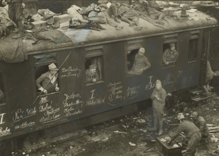 Soldiers on trains passing through Bolzano station.