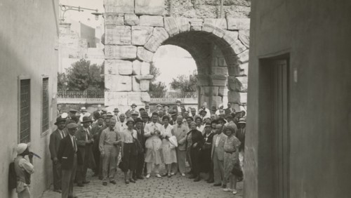 Excursionists in front of the Arch of Marcus Aurelius in Tripoli. 
	
		1931