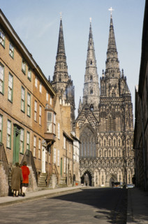 People walking in The Close towards Lichfield cathedral church, Lichfield, Staffordshire, England,