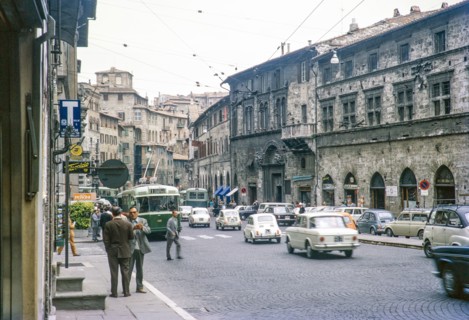 Traffic and tram cars of busy city street in Perugia, Umbria, Italy 1969.