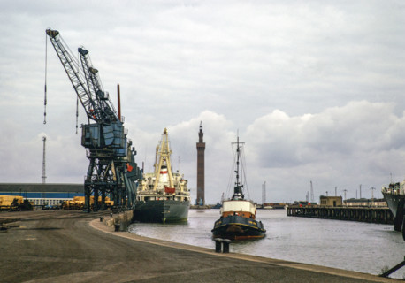 Cargo ships and 'Lady Sybil' tug boat, Royal Dock with Grimsby Dock Tower, Grimsby, Lincolnshire,