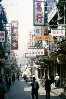 Busy street of shops and signs in English and Mandarin including for Tai Cheong Tailors, Wellington