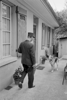 Postman using a spray to keep away dogs, 1966