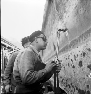 Preparation of overland ship transpor, cutting hull in two with blowtorch, 1946