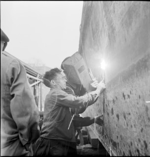 Preparation of overland ship transpor, cutting hull in two with blowtorch, 1946
