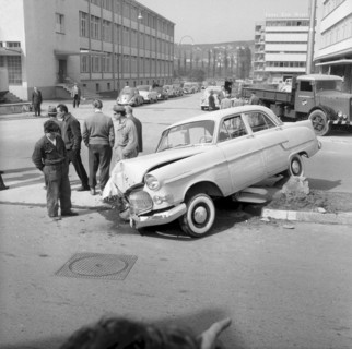 Workers watching a damaged car 1959