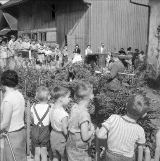 Traffic accident, onlookers watching a car in a front garden, Lucerne 1959