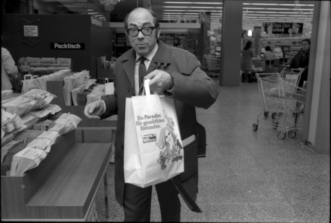 Man with bag in the shopping center Spreitenbach 1970