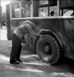 Bus driver checking chains for tyre protection, Berne 1945