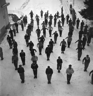Ski instructors doing gymnastics before skiing, Davos 1940
