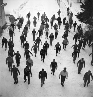 Ski instructors doing gymnastics before skiing, Davos 1940