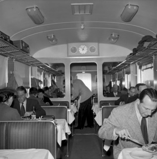 Waiter serving customers in a dining car 1951