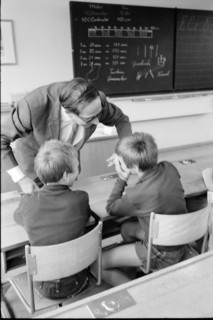 Teacher and pupils playing scene of corporal punishment, 1969,
