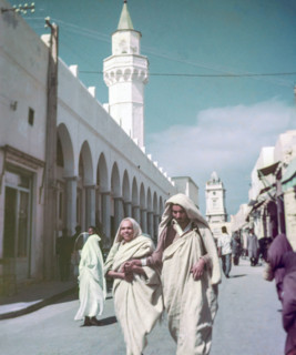 Leading blind person in street.