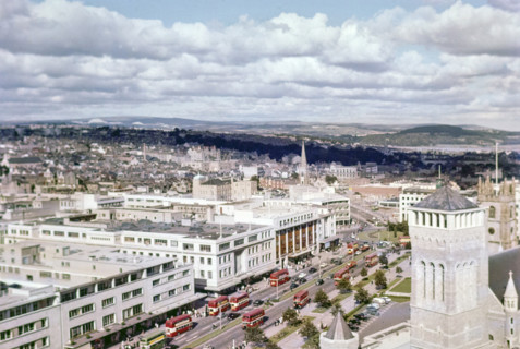 View over Royal Parade city centre street with red double decker buses.