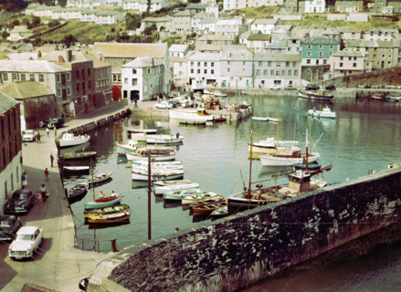 Boats at moorings in the harbour at seaside fishing village of Mevagissey.