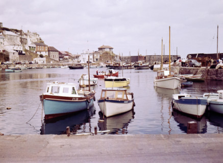 Boats at moorings in the harbour at seaside fishing village of Mevagissey.