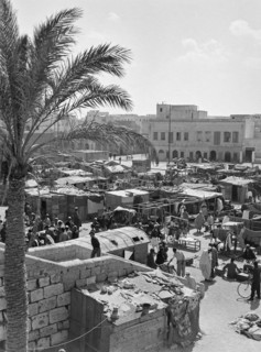 Market stalls and people in market souk in media old town area of Tripoli.