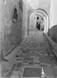 Archways in narrow alleyway street in Medina old town area.