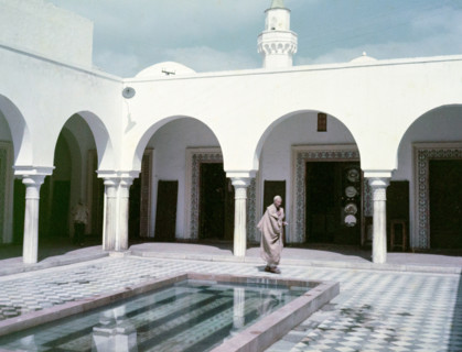 Arabic architectural style in courtyard with water pool.