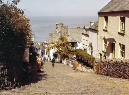 Steep hill of cobbled main street in coastal village of Clovelly.