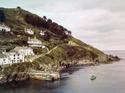Historic waterfront buildings around the harbour river mouth of the River Pol at village of Polperro.