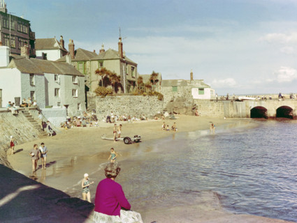 People in swimsuits on sandy beach at The Wharf.