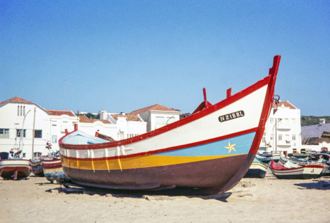 Traditional fishing boat on beach.