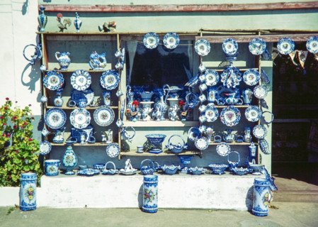 Shop front display of blue and white ceramic Alcobaca style pottery.