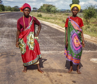 Two women in vibrant traditional Swazi or Zulu attire, showcasing the rich cultural heritage and colorful textiles of Southern Africa