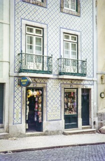 Typical Portuguese building facade with blue and white azulejo tiles shop selling film and souvenirs