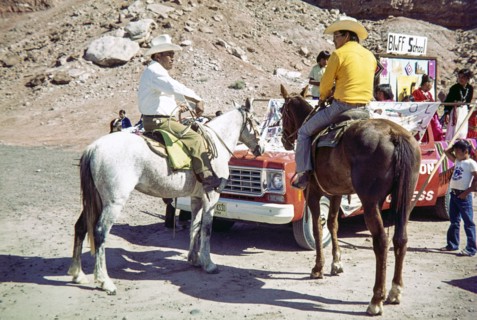 Two men on horseback.