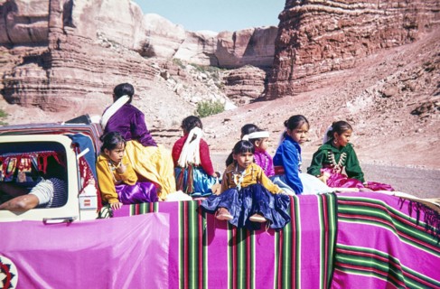 Dine Navajo children and families sitting on back of a truck.