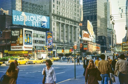 Advertising billboards yellow taxi cabs.