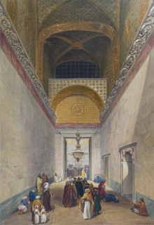 Main entrance to the Ayasofya Mosque with groups of men in traditional dress.
