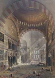 General view of the large nave, facing east of Ayasofya Mosque with groups of men in traditional dress.