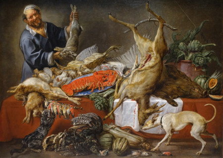 The cook is at the table with wildfowl.