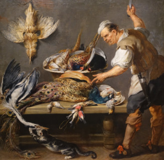 Cook at a table with wildfowl.