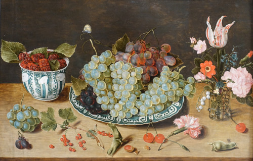 Still life with grapes, berries and a bouquet of flowers.
