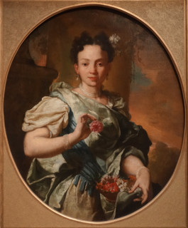 A young girl with a flower basket.