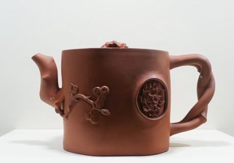 Teapot with an umbrella pine, a bat, and a blossoming mei plum branch on the lid.