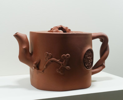 Teapot with an umbrella pine, a bat, and a blossoming mei plum branch on the lid.