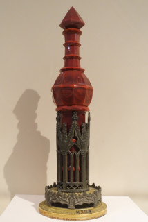 Cologne bottle on stand.