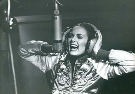 Lynda Carter in studio wearing headphones while recording