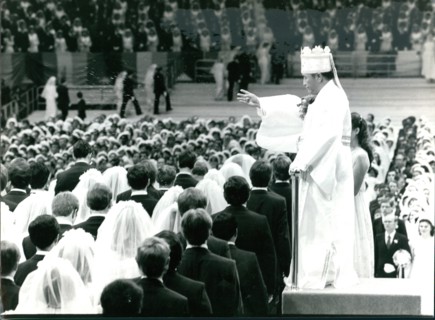 Reverand Sun Yung Moon presides over a mass wedding ceremony for the Unification Church at Madison Square Garden